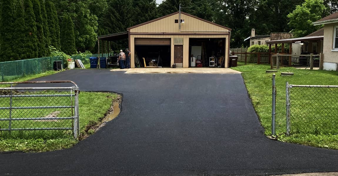 Newly paved blacktop driveway after repair in Raymond, OH