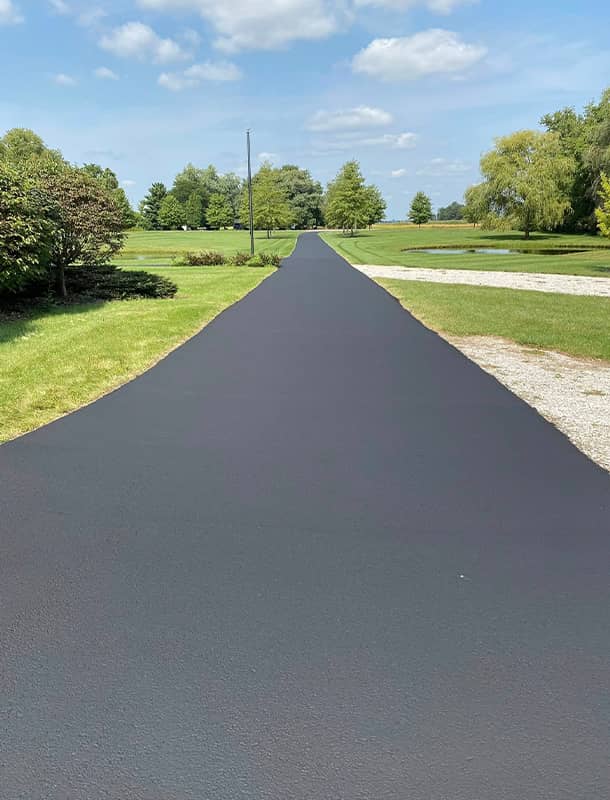 Long freshly sealed rural driveway in Plain City, OH