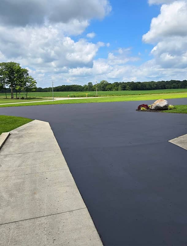 Newly sealed driveway turnaround overlooking farmland in West Liberty, OH